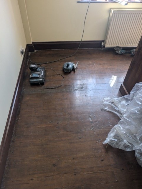 Sanding varnished pine floorboards in Chippenham